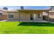 The backyard has a covered patio, a well-kept lawn, and privacy fencing for outdoor living and entertaining at 1946 E Kings Ave, Phoenix, AZ 85022