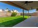 A backyard featuring a lush green lawn, privacy fence, and covered patio area at 1946 E Kings Ave, Phoenix, AZ 85022