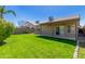 Enjoy the outdoors in this backyard featuring a covered patio, lush lawn, and privacy fencing for serene living at 1946 E Kings Ave, Phoenix, AZ 85022