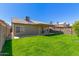 This spacious backyard offers a covered patio, mature landscaping, and ample green space for relaxation and recreation at 1946 E Kings Ave, Phoenix, AZ 85022