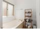 Relaxing bathroom featuring a soaking tub, a bamboo shelf, and ample natural light at 1946 E Kings Ave, Phoenix, AZ 85022