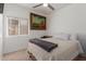 Bright bedroom with a cozy bed, neutral walls, and natural light from the window at 1946 E Kings Ave, Phoenix, AZ 85022