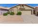 Charming single-story home with a beige exterior, well-manicured landscaping, and a two-car garage at 1946 E Kings Ave, Phoenix, AZ 85022