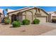 Inviting home exterior with a neutral color palette, manicured bushes, and a two-car garage at 1946 E Kings Ave, Phoenix, AZ 85022