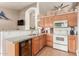 Well-equipped kitchen featuring white appliances, granite counters, oak cabinets, and a wine cooler at 1946 E Kings Ave, Phoenix, AZ 85022