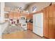 Bright kitchen featuring granite countertops, white appliances, light wood cabinets and ample storage at 1946 E Kings Ave, Phoenix, AZ 85022