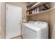 Functional laundry room featuring a washer, dryer, and shelving for storage solutions at 1946 E Kings Ave, Phoenix, AZ 85022