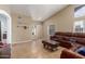 Bright living room featuring tile flooring, a leather sofa, and neutral walls at 1946 E Kings Ave, Phoenix, AZ 85022