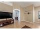 Cozy living room showcasing tile flooring, neutral walls, and modern entertainment center at 1946 E Kings Ave, Phoenix, AZ 85022