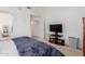 Bright main bedroom boasts a ceiling fan, plush carpeting, and a TV entertainment unit at 1946 E Kings Ave, Phoenix, AZ 85022