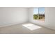 Bright bedroom with a large window offering natural light and a view of the neighborhood at 21292 N 270Th Dr, Buckeye, AZ 85396
