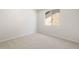 A well-lit carpeted bedroom with a window that offers an outside view at 21292 N 270Th Dr, Buckeye, AZ 85396