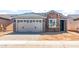 Charming single-story home with a brick and concrete facade, featuring a two-car garage and neat landscaping at 21292 N 270Th Dr, Buckeye, AZ 85396