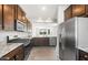 Well-equipped kitchen featuring granite countertops, stainless steel appliances, and dark wood cabinetry at 21292 N 270Th Dr, Buckeye, AZ 85396