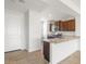 Modern kitchen featuring tile flooring, granite countertops, stainless steel appliances, and dark wood cabinetry at 21292 N 270Th Dr, Buckeye, AZ 85396