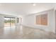 Bright living room with tile flooring, recessed lighting, sliding glass doors to the yard and a large window at 21292 N 270Th Dr, Buckeye, AZ 85396