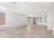 Open-concept living area featuring light tile flooring, recessed lighting, and views into the kitchen and other rooms at 21292 N 270Th Dr, Buckeye, AZ 85396