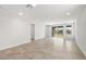 Spacious living room with light tile flooring, recessed lighting, and access to the backyard through sliding glass doors at 21292 N 270Th Dr, Buckeye, AZ 85396