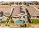 Aerial view showcases a well-maintained property with a pool, spa, and solar panels for energy efficiency at 24270 N 173Rd Ave, Surprise, AZ 85387