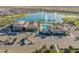 Community clubhouse with a resort-style pool, palm trees, and lake views at 24270 N 173Rd Ave, Surprise, AZ 85387
