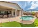 This backyard oasis includes a sparkling pool, lush artificial grass, and a covered patio perfect for relaxation at 24270 N 173Rd Ave, Surprise, AZ 85387
