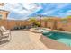 This beautiful backyard features a pool, spa, and lush landscaping, perfect for relaxation and outdoor gatherings at 24270 N 173Rd Ave, Surprise, AZ 85387