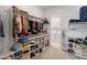 Organized walk-in closet with custom shelving and rods, leading to the laundry room at 24270 N 173Rd Ave, Surprise, AZ 85387