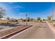 Inviting community entrance with stone signage, landscaped surroundings and clear blue skies at 24270 N 173Rd Ave, Surprise, AZ 85387