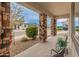 Inviting covered porch supported by decorative stone pillars, creating a perfect spot to relax outdoors at 24270 N 173Rd Ave, Surprise, AZ 85387