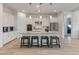 Stylish kitchen featuring white cabinets, a large island with seating, and pendant lighting at 24270 N 173Rd Ave, Surprise, AZ 85387