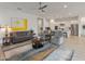 Open-concept living room with a view of the kitchen and modern furnishings at 24270 N 173Rd Ave, Surprise, AZ 85387