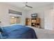 Cozy main bedroom with backyard pool views and a built-in entertainment center at 24270 N 173Rd Ave, Surprise, AZ 85387