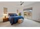 Bright main bedroom features outdoor access, carpet, and soft lighting at 24270 N 173Rd Ave, Surprise, AZ 85387