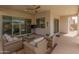 Relaxing outdoor patio with comfortable seating, a ceiling fan, and views of the pool at 24270 N 173Rd Ave, Surprise, AZ 85387