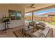 Inviting covered patio with comfortable seating, overlooking the pool and spa area at 24270 N 173Rd Ave, Surprise, AZ 85387