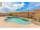 Sparkling pool and lush landscaping create a serene backyard retreat, perfect for enjoying sunny days and outdoor living at 24270 N 173Rd Ave, Surprise, AZ 85387