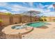 Backyard features a spa, pool, and privacy wall that creates a private oasis for relaxation and recreation at 24270 N 173Rd Ave, Surprise, AZ 85387