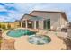 Private backyard oasis with pool, spa, covered patio, and ample space for entertaining in the Arizona sun at 24270 N 173Rd Ave, Surprise, AZ 85387