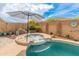 Enjoy the spa nestled beside the pool surrounded by lush landscaping and the perfect private backyard retreat at 24270 N 173Rd Ave, Surprise, AZ 85387