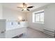 This bedroom offers a ceiling fan, a window, and bright white furniture at 2469 S Sailors Ct, Gilbert, AZ 85295