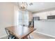 Dining area adjacent to kitchen features windows and modern lighting at 2469 S Sailors Ct, Gilbert, AZ 85295