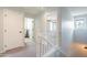 Upstairs hallway with carpet and access to a bedroom; bright natural light from a window at 2469 S Sailors Ct, Gilbert, AZ 85295