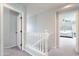 Upstairs hallway featuring neutral paint, carpet, and access to a bedroom at 2469 S Sailors Ct, Gilbert, AZ 85295