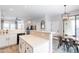 Open kitchen with breakfast bar, stainless appliances, and view into breakfast nook at 2469 S Sailors Ct, Gilbert, AZ 85295