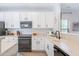 Bright kitchen features white cabinets, granite countertops, and stainless steel appliances at 2469 S Sailors Ct, Gilbert, AZ 85295