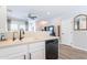 Kitchen features stainless dishwasher and sink plus serving bar at 2469 S Sailors Ct, Gilbert, AZ 85295