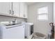 This laundry room has modern appliances and a window for natural light at 2469 S Sailors Ct, Gilbert, AZ 85295