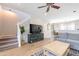 Bright living room featuring hardwood floors, modern decor, and an open stairway at 2469 S Sailors Ct, Gilbert, AZ 85295