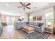 Spacious living room featuring modern ceiling fan, neutral walls, and stylish area rug at 2469 S Sailors Ct, Gilbert, AZ 85295