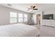 A light-filled main bedroom with a ceiling fan, dresser and ample natural light at 2469 S Sailors Ct, Gilbert, AZ 85295